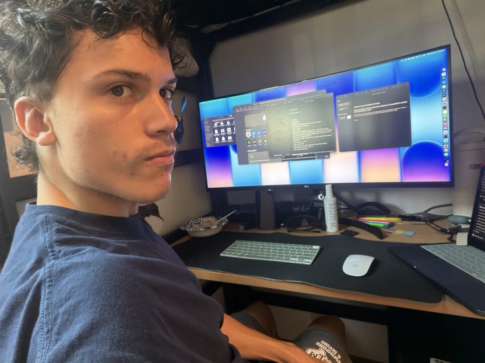 Ben at his desk, with a project open on a wide monitor